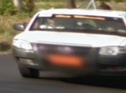 Zoomed in picture of blurred orange license plate